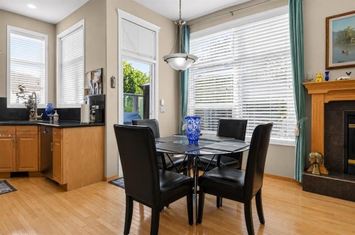 44 Strathlea Close Sw, Calgary, AB - Indoor Photo Showing Dining Room With Fireplace