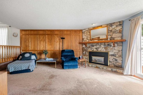 84 Deermoss Crescent Se, Calgary, AB - Indoor Photo Showing Living Room With Fireplace