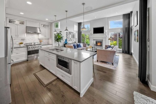 656 Quarry Way Se, Calgary, AB - Indoor Photo Showing Kitchen With Fireplace With Double Sink With Upgraded Kitchen