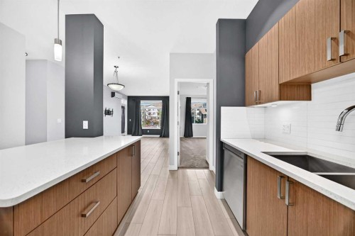 202-10 Auburn Bay Link Se, Calgary, AB - Indoor Photo Showing Kitchen With Double Sink With Upgraded Kitchen