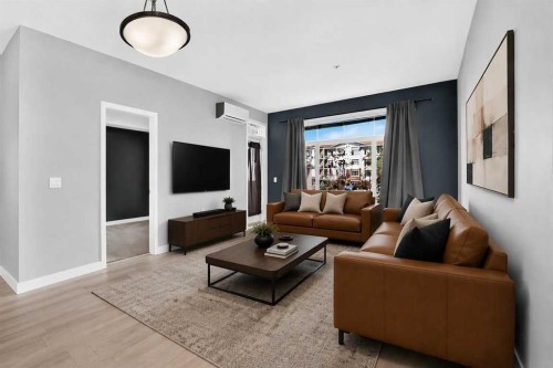 202-10 Auburn Bay Link Se, Calgary, AB - Indoor Photo Showing Living Room