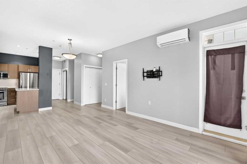 202-10 Auburn Bay Link Se, Calgary, AB - Indoor Photo Showing Kitchen With Stainless Steel Kitchen