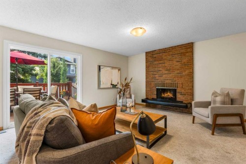 92 Canova Road Sw, Calgary, AB - Indoor Photo Showing Living Room With Fireplace