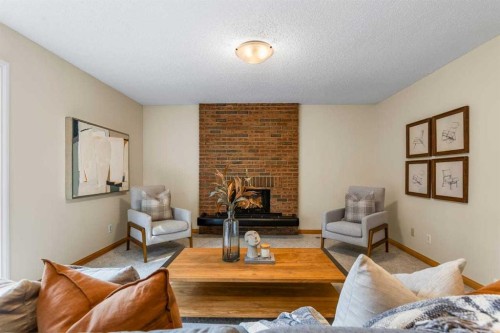 92 Canova Road Sw, Calgary, AB - Indoor Photo Showing Living Room With Fireplace