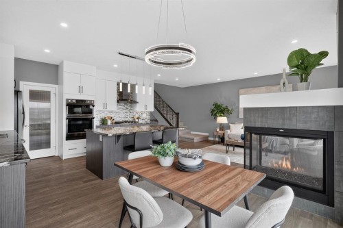 32 Legacy Cove Se, Calgary, AB - Indoor Photo Showing Dining Room With Fireplace