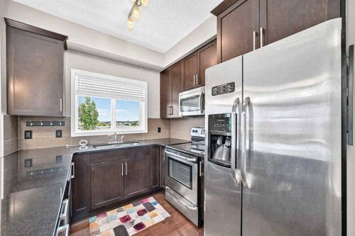 2401-175 Panatella Hill Nw, Calgary, AB - Indoor Photo Showing Kitchen With Stainless Steel Kitchen With Upgraded Kitchen