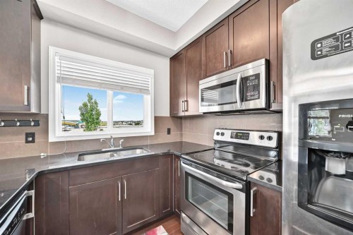2401-175 Panatella Hill Nw, Calgary, AB - Indoor Photo Showing Kitchen With Stainless Steel Kitchen With Double Sink