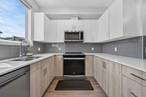 433-301 Redstone Boulevard Ne, Calgary, AB - Indoor Photo Showing Kitchen With Stainless Steel Kitchen With Double Sink