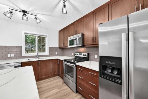 86 Pantego Lane Nw, Calgary, AB - Indoor Photo Showing Kitchen With Double Sink With Upgraded Kitchen