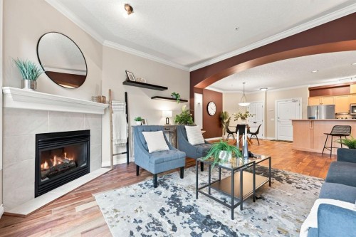 209-59 22 Avenue Sw, Calgary, AB - Indoor Photo Showing Living Room With Fireplace