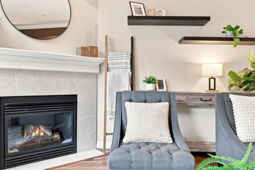 209-59 22 Avenue Sw, Calgary, AB - Indoor Photo Showing Living Room With Fireplace