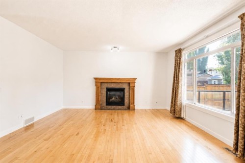 108 Tuscany Estates Close Nw, Calgary, AB - Indoor Photo Showing Living Room With Fireplace