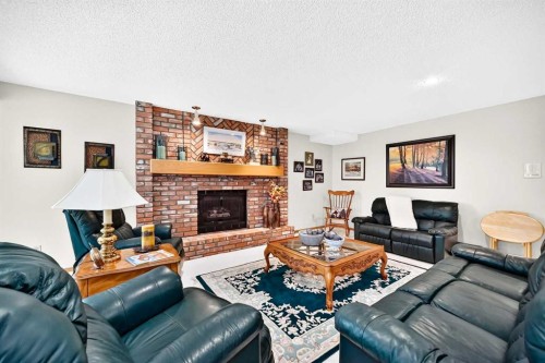 36 Sunset Way, Priddis Greens, AB - Indoor Photo Showing Living Room With Fireplace