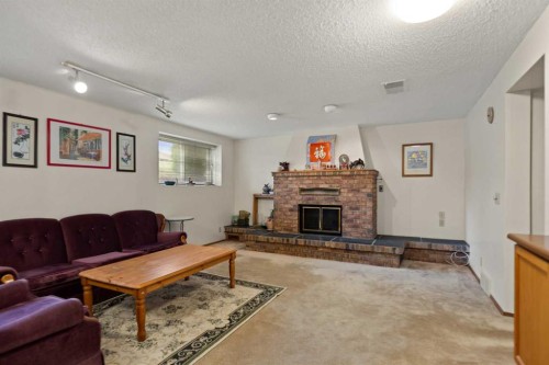224 Berwick Way Nw, Calgary, AB - Indoor Photo Showing Living Room With Fireplace