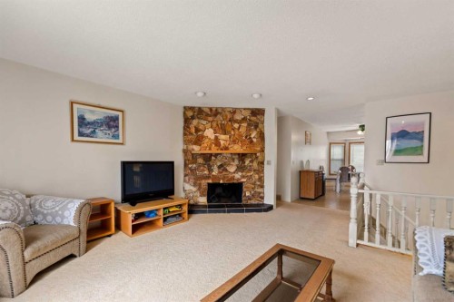 224 Berwick Way Nw, Calgary, AB - Indoor Photo Showing Living Room With Fireplace