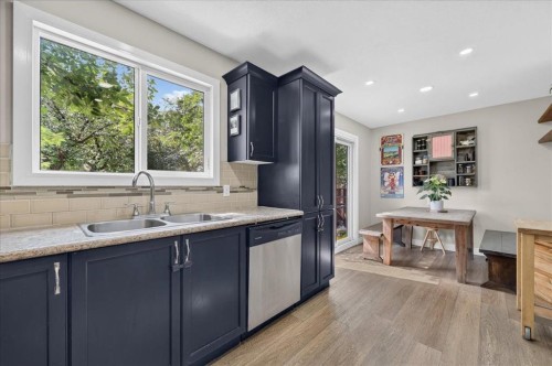 57 Beacham Way Nw, Calgary, AB - Indoor Photo Showing Kitchen With Double Sink