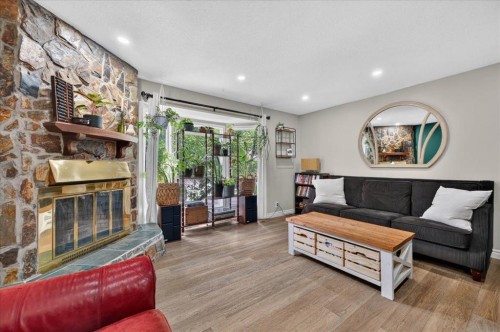 57 Beacham Way Nw, Calgary, AB - Indoor Photo Showing Living Room With Fireplace
