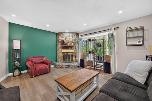 57 Beacham Way Nw, Calgary, AB - Indoor Photo Showing Living Room With Fireplace