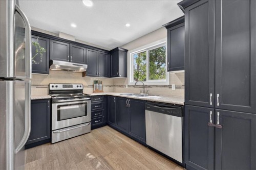 57 Beacham Way Nw, Calgary, AB - Indoor Photo Showing Kitchen With Stainless Steel Kitchen With Double Sink
