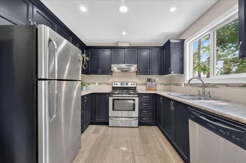 57 Beacham Way Nw, Calgary, AB - Indoor Photo Showing Kitchen With Stainless Steel Kitchen