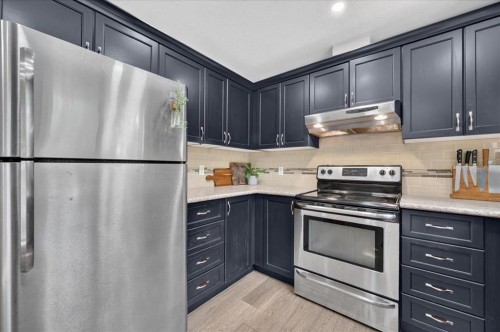 57 Beacham Way Nw, Calgary, AB - Indoor Photo Showing Kitchen With Stainless Steel Kitchen With Upgraded Kitchen