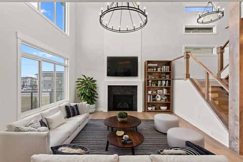 87 Sundown Crescent, Cochrane, AB - Indoor Photo Showing Living Room With Fireplace