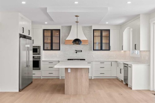 87 Sundown Crescent, Cochrane, AB - Indoor Photo Showing Kitchen With Upgraded Kitchen