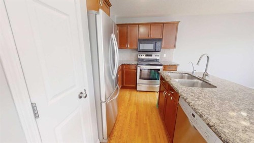 124 Everglen Way Sw, Calgary, AB - Indoor Photo Showing Kitchen With Stainless Steel Kitchen With Double Sink