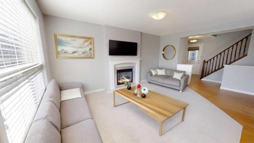 124 Everglen Way Sw, Calgary, AB - Indoor Photo Showing Living Room With Fireplace