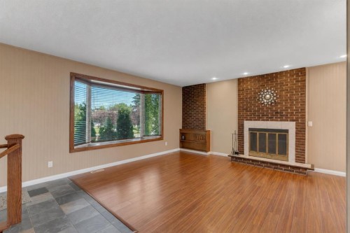 335 Queensland Drive Se, Calgary, AB - Indoor With Fireplace