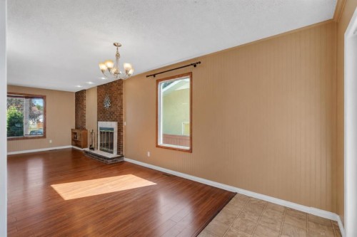335 Queensland Drive Se, Calgary, AB - Indoor With Fireplace
