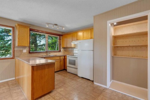 335 Queensland Drive Se, Calgary, AB - Indoor Photo Showing Kitchen With Double Sink