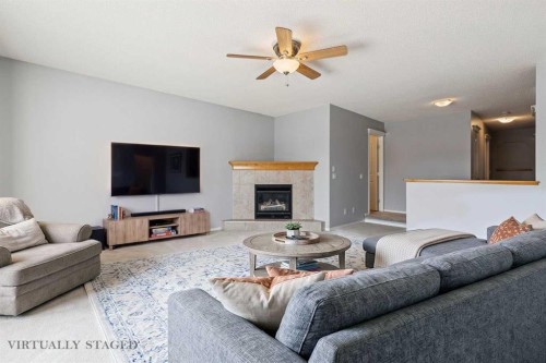 258 West Ranch Place Sw, Calgary, AB - Indoor Photo Showing Living Room With Fireplace