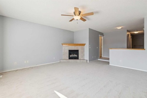 258 West Ranch Place Sw, Calgary, AB - Indoor Photo Showing Other Room With Fireplace