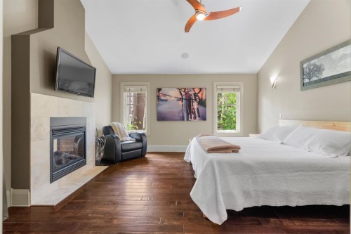 136 Posthill Drive Sw, Calgary, AB - Indoor Photo Showing Bedroom With Fireplace