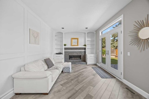 8 Millside Court Sw, Calgary, AB - Indoor Photo Showing Living Room With Fireplace