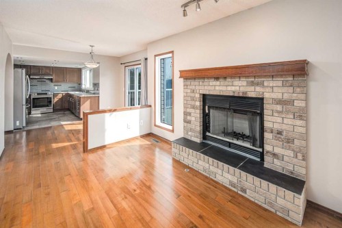 131 Edgebrook Close Nw, Calgary, AB - Indoor Photo Showing Living Room With Fireplace