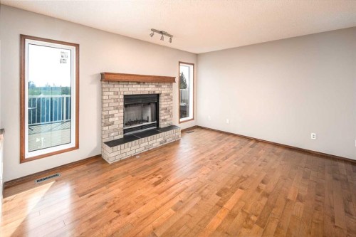 131 Edgebrook Close Nw, Calgary, AB - Indoor Photo Showing Living Room With Fireplace