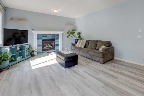 242 Crystal Green Point, Okotoks, AB - Indoor Photo Showing Living Room With Fireplace