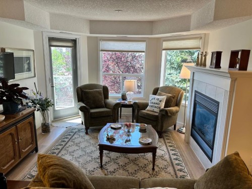 3338-1818 Simcoe Boulevard Sw, Calgary, AB - Indoor Photo Showing Living Room With Fireplace