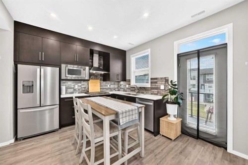 203-120 Redstone Walk Ne, Calgary, AB - Indoor Photo Showing Kitchen With Stainless Steel Kitchen With Upgraded Kitchen