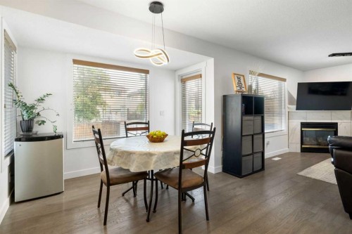 56 West Cedar Rise Sw, Calgary, AB - Indoor Photo Showing Dining Room With Fireplace