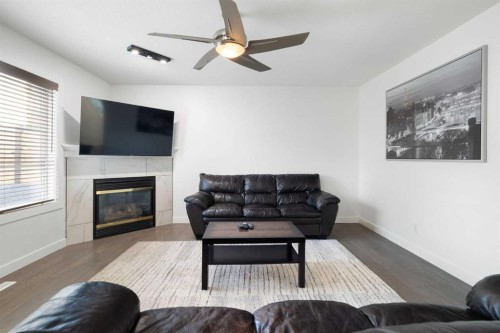 56 West Cedar Rise Sw, Calgary, AB - Indoor Photo Showing Living Room With Fireplace
