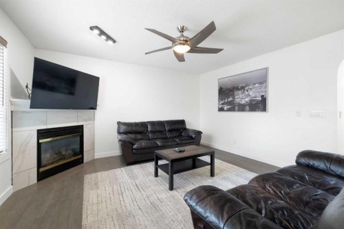 56 West Cedar Rise Sw, Calgary, AB - Indoor Photo Showing Living Room With Fireplace