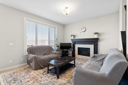 215 Redstone Heights Ne, Calgary, AB - Indoor Photo Showing Living Room With Fireplace