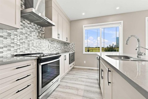 142 Yorkstone Way Sw, Calgary, AB - Indoor Photo Showing Kitchen With Double Sink With Upgraded Kitchen