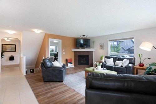2 Kingston View Se, Airdrie, AB - Indoor Photo Showing Living Room With Fireplace