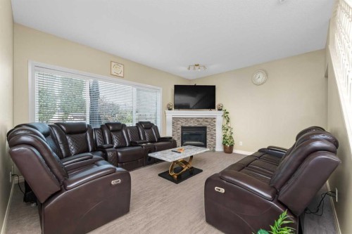 135 Kincora Drive Nw, Calgary, AB - Indoor Photo Showing Living Room With Fireplace