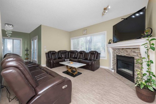 135 Kincora Drive Nw, Calgary, AB - Indoor Photo Showing Living Room With Fireplace