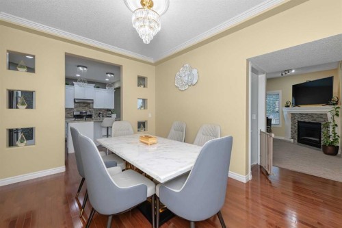 135 Kincora Drive Nw, Calgary, AB - Indoor Photo Showing Dining Room With Fireplace